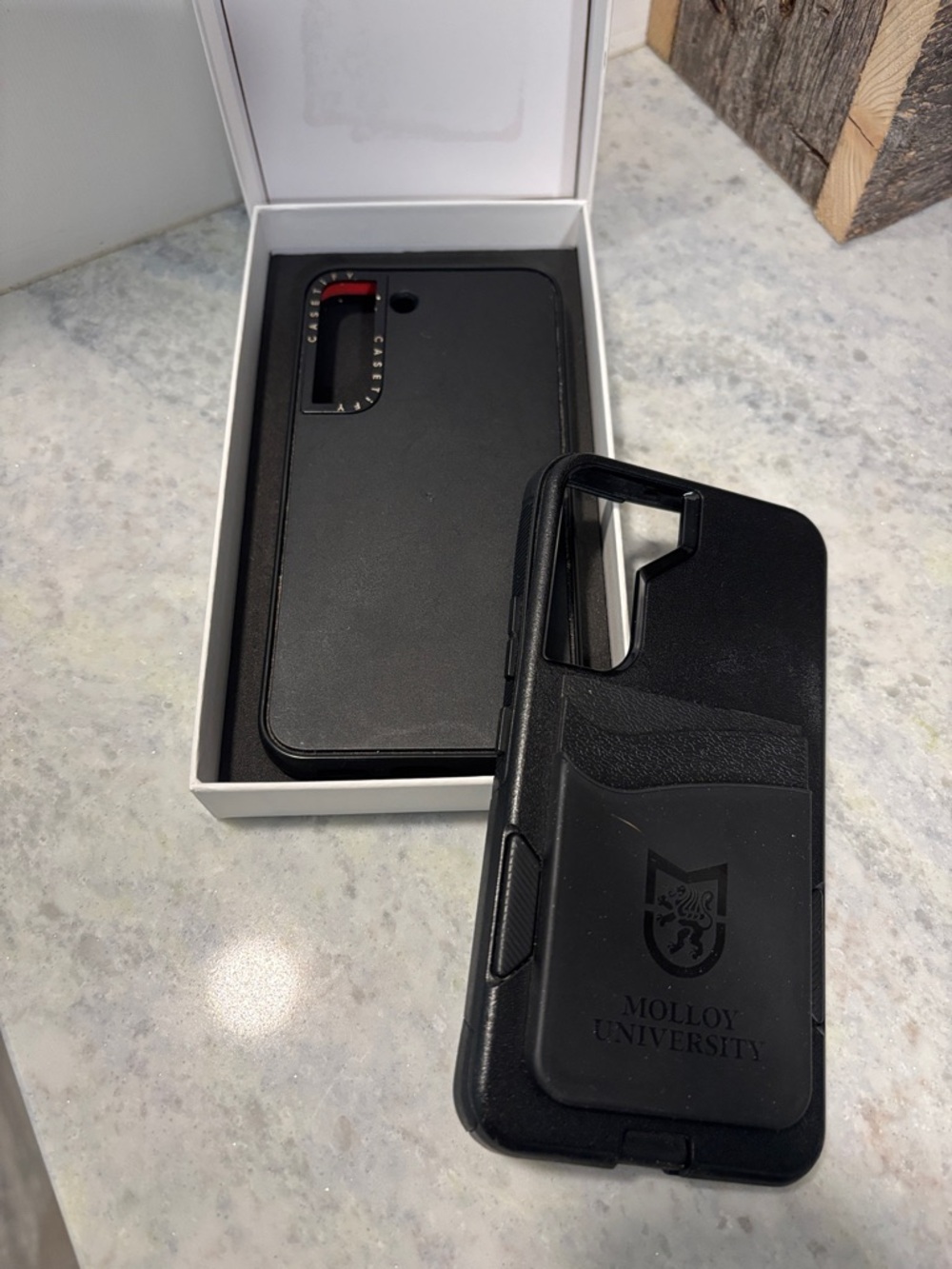 Two Samsung S22 Cases Casetify and Otterbox Black in color